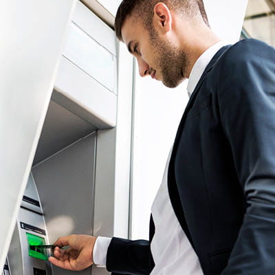 man using an ATM