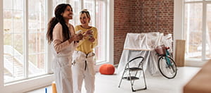 Two people smiling in home renovation space