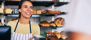 Person paying with phone with a handheld card reader