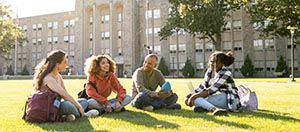 People sitting on campus lawn