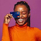 Person holding a credit card and smiling