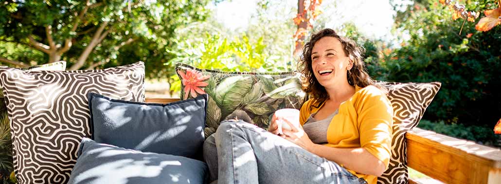 Person smiling on outdoor sofa