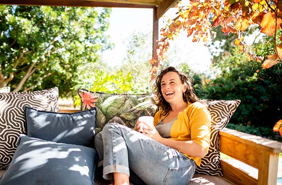 Person smiling on outdoor sofa