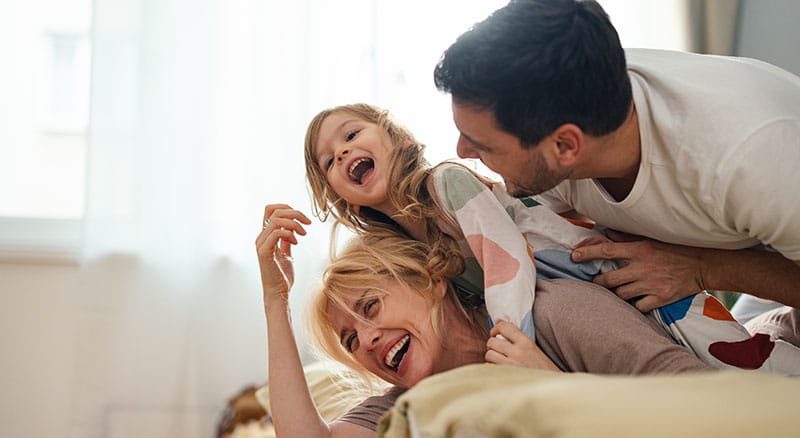 Family laying down and laughing 
