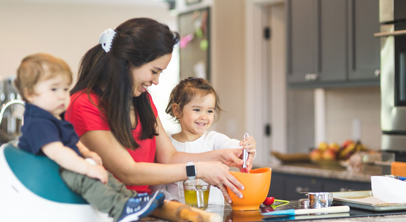 Mom bakes with her two young children