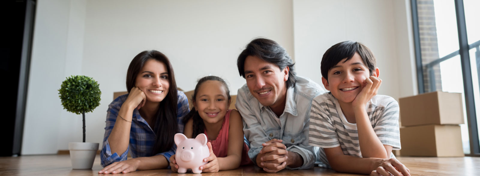 Mother, daughter, father and son celebrate saving for a major purchase with guidance from a Banner Investment Services advisor.