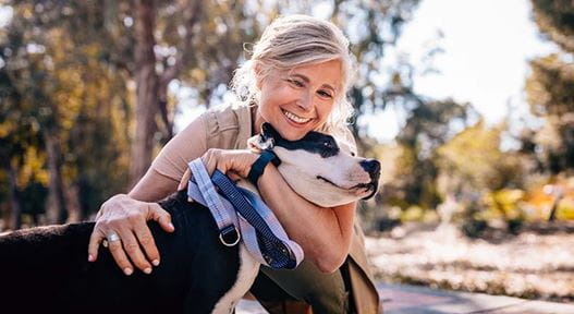 Person hugging dog outside