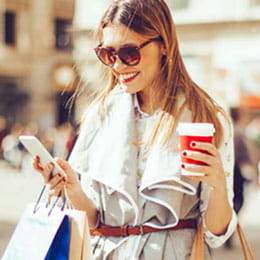Shopper banks on mobile app while drinking coffee