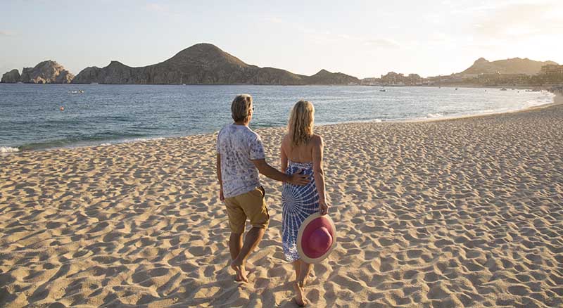 Couple walking in the sand on the beach in Mexico