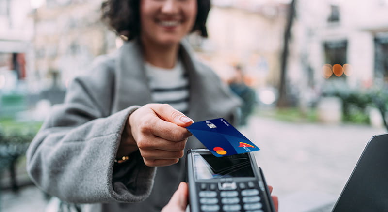 Person paying with TruRewards card at a mobile card reader
