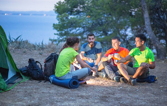 Friends camping near a lake