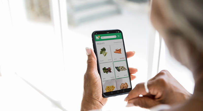 Stand up to cancer and mastercard logos over photo of couple with takeout