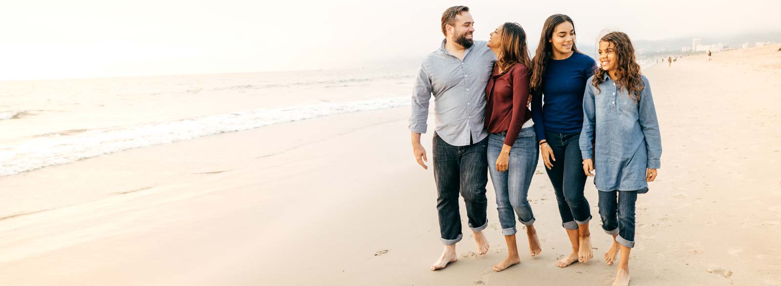Family walks on beach