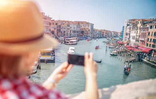 Traveler takes picture of Venice with smartphone