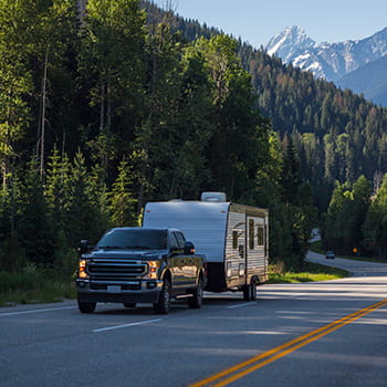 Truck with trailer driving in the mountains