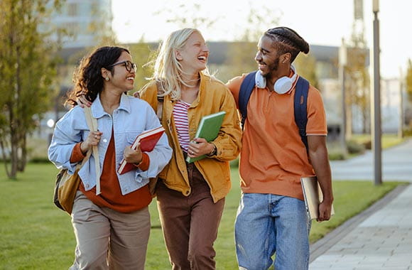 three students walking and laughing