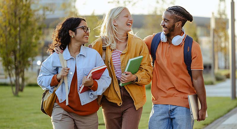 three students walking and laughing