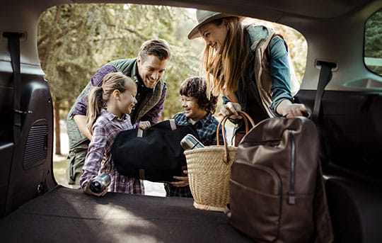 Family packing up new car for adventure