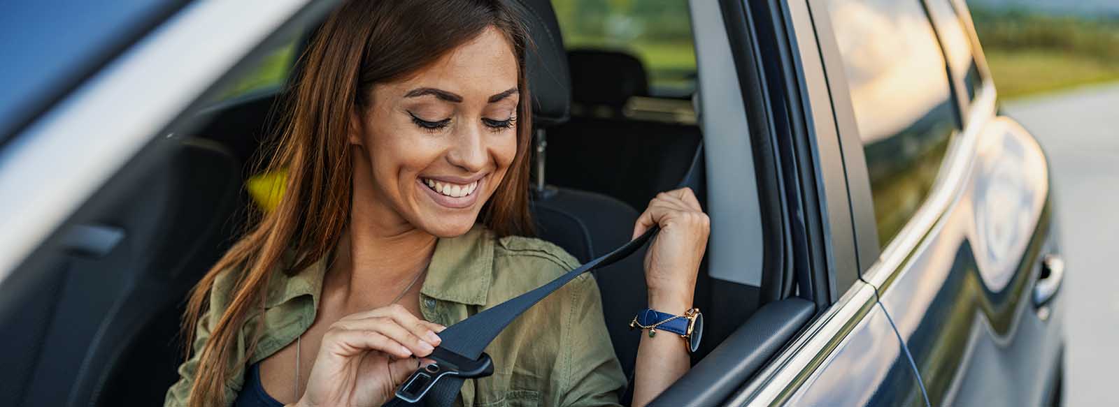 Women in car buckling her seatbelt