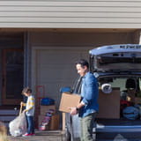 Father and son unpack car and move into their new home, financed by Banner Bank