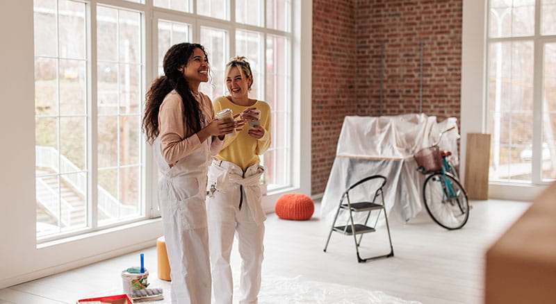 Two people looking a space being renovated