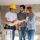 Couple discussing remodel plans with a contractor