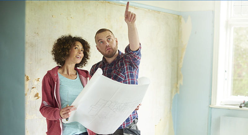 Couple looking at renovation plans