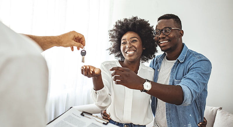 First time home buyers receiving keys to their new home