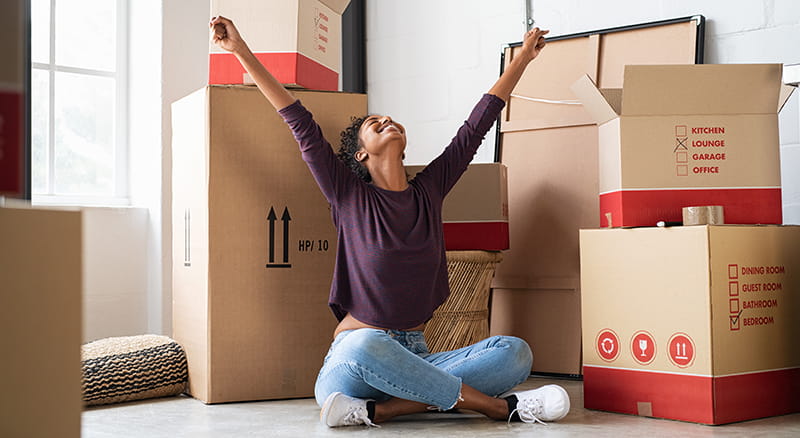 Woman sitting on the floor with arms outstretched
