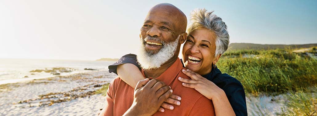 Two people smiling on the beach