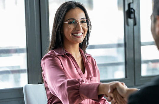Banker shakes hands with customer