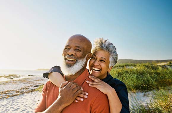 Two people smiling on the beach