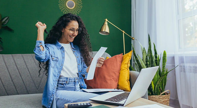 Woman opens letter and celebrates