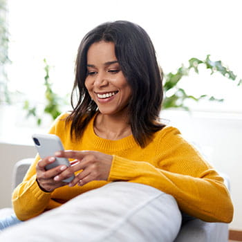 Person smiling at cell phone
