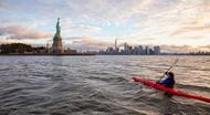 Person kayaking to Statue of Liberty in New York