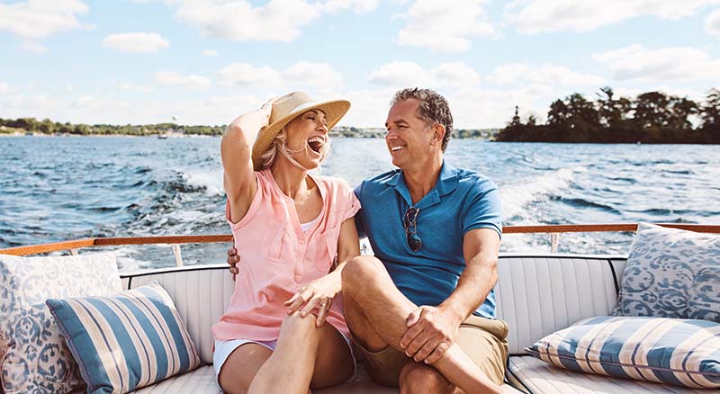 Couple smiling and laughing on boat