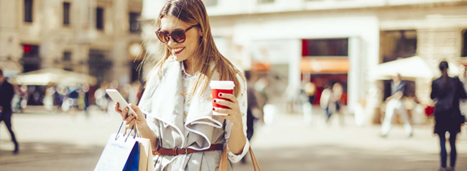 Woman with shopping bags and using her phone
