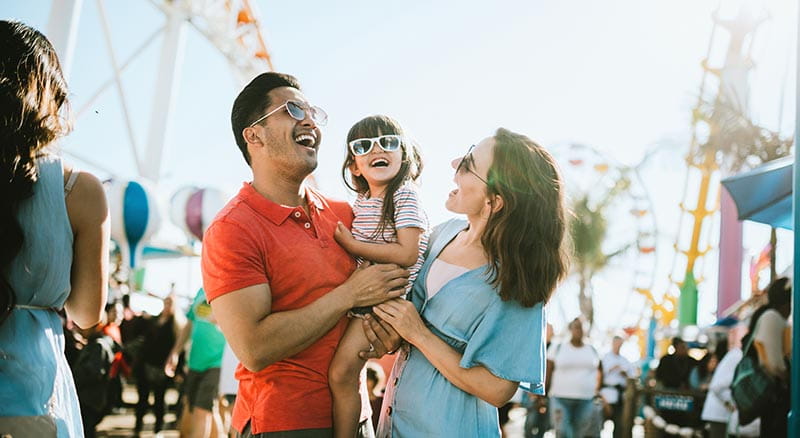 Family smiling at amusement park