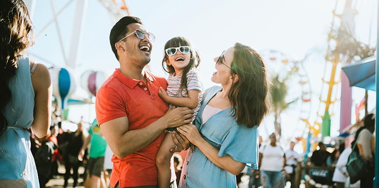 Family smiling at amusement park