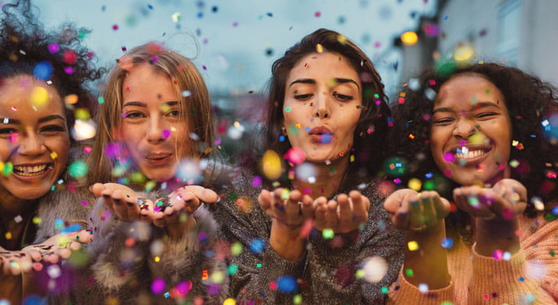 Confetti falls on four friends