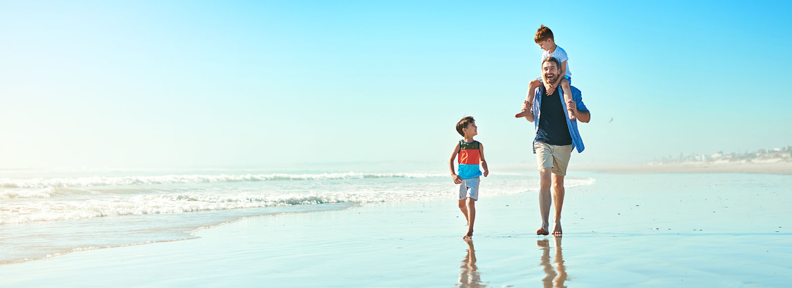 Photo of family walking on beach