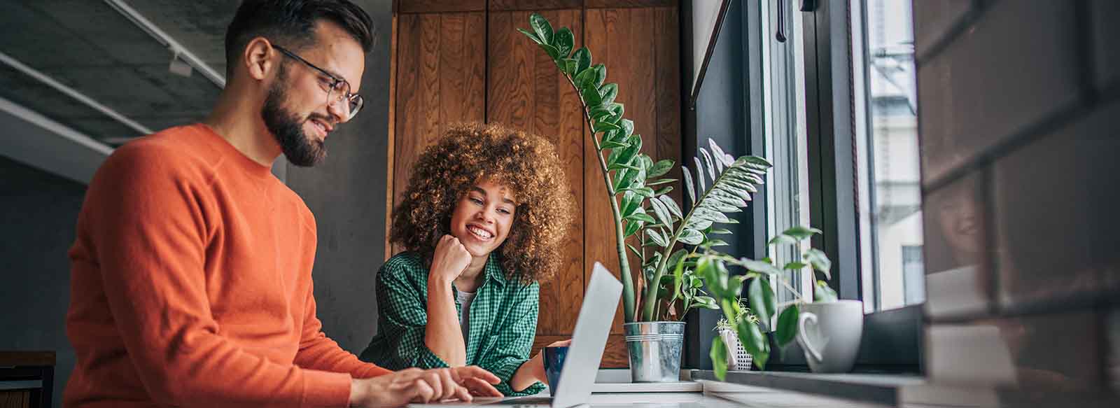 Two people looking at laptop
