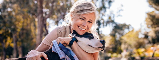 Person hugging dog outside