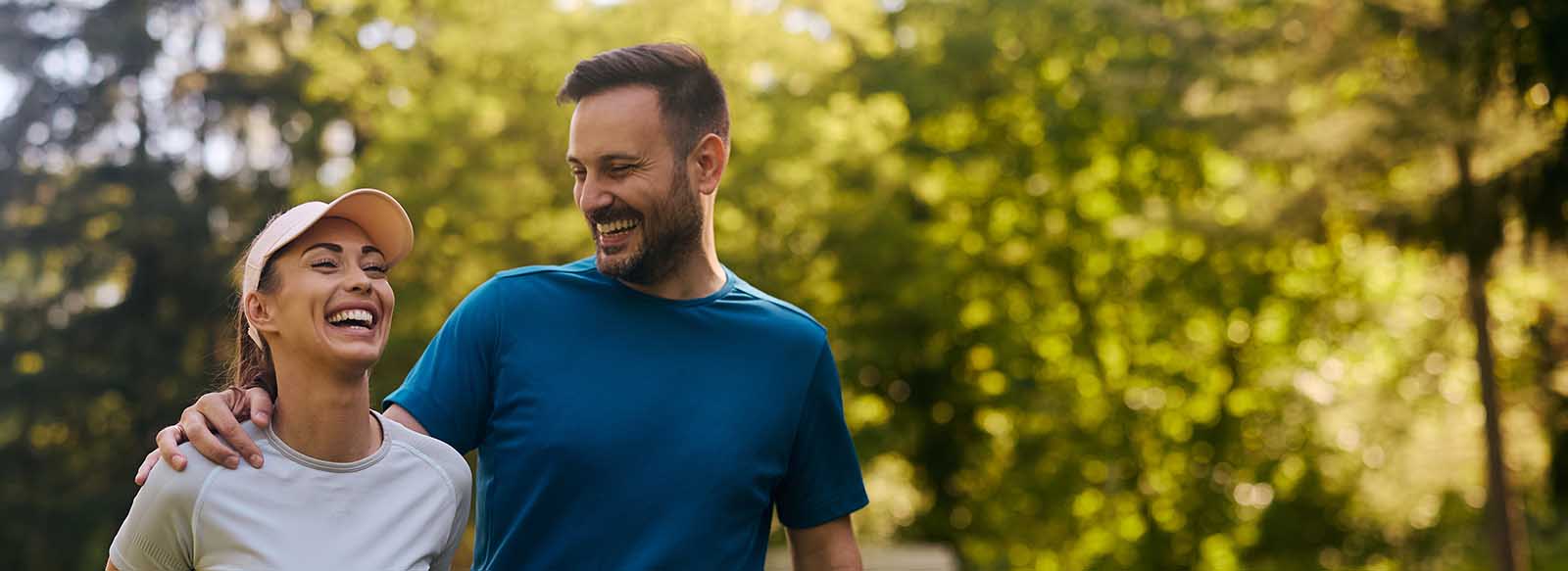 Two people walking outside and smiling