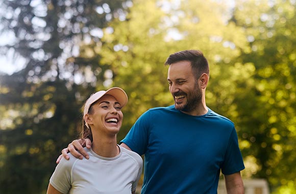 Two people walking outside and smiling