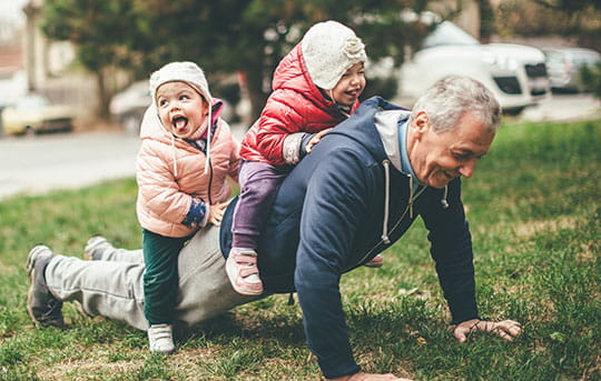 Grandparent playing with his two young grandchildren