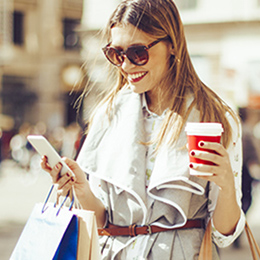 Woman with shopping bags using mobile phone