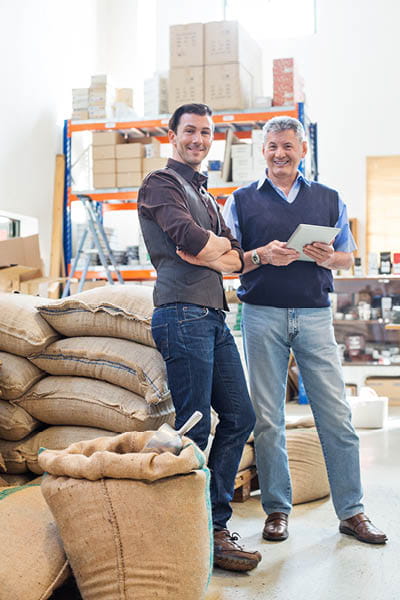two guys standing in a warehouse