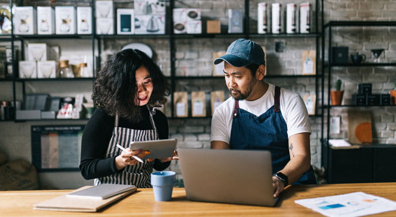 Two workers review inventory
