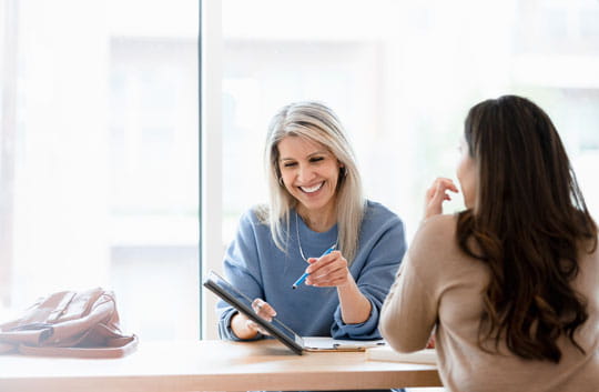 Meeting with a financial advisor and reviewing portfolio on a tablet